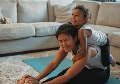 Parent doing quiet stretches at home